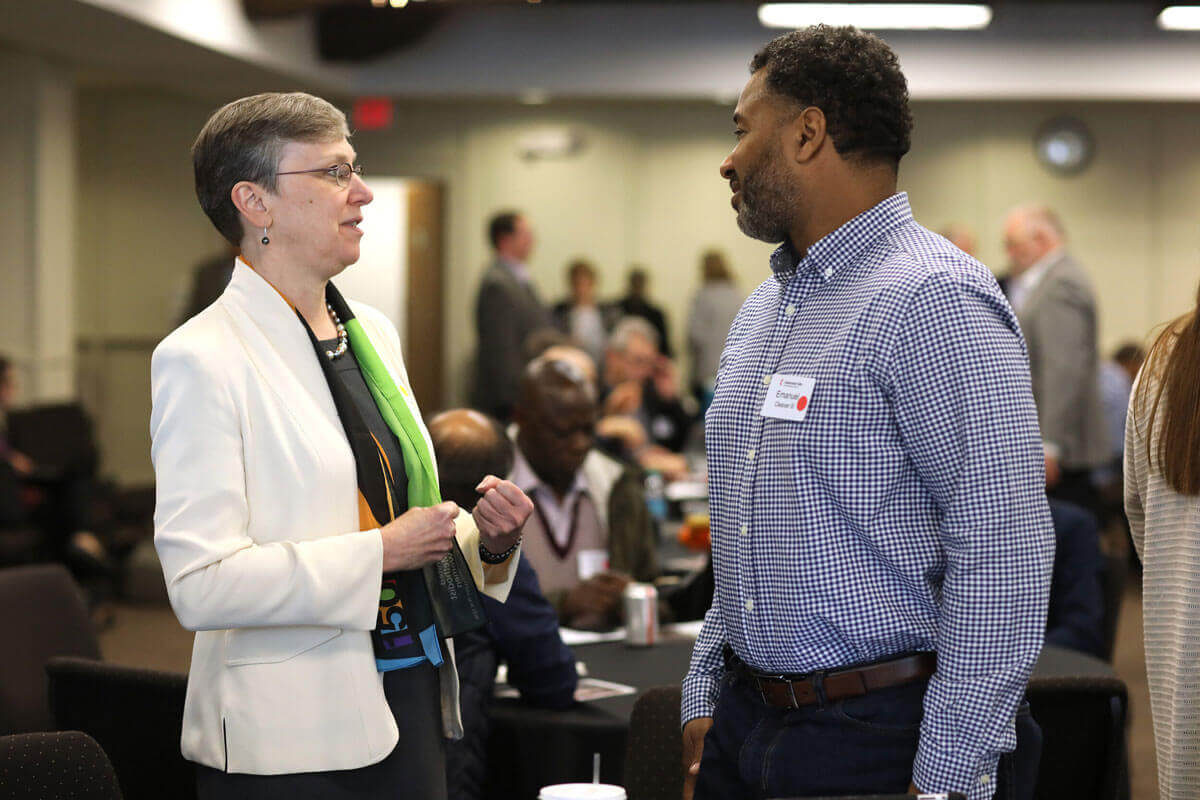 Harriet Olsen talks with the Rev. Emmanuel Clever III during the Connectional Table meeting held at United Methodist Discipleship Ministries in Nashville, Tenn., April 2. Photo by Kathleen Barry, UM News