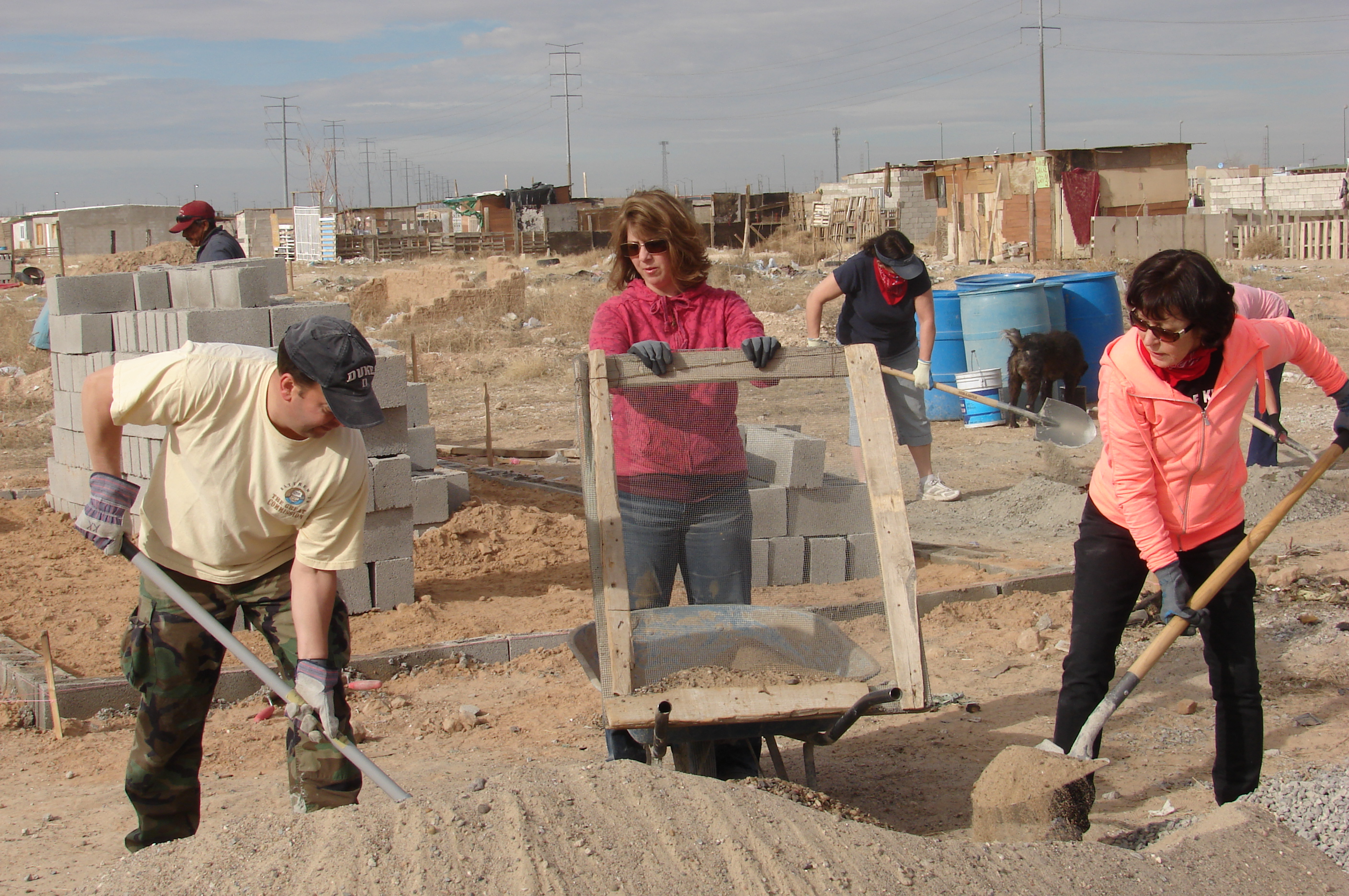 Mission team members from Suncreek United Methodist Church sift out rocks as part of the mortar-making process. They spent three days building a cinder-block home for the Quinoñes family of Ciudad Juárez, Mexico. Photo by Sam Hodges, UMNS 