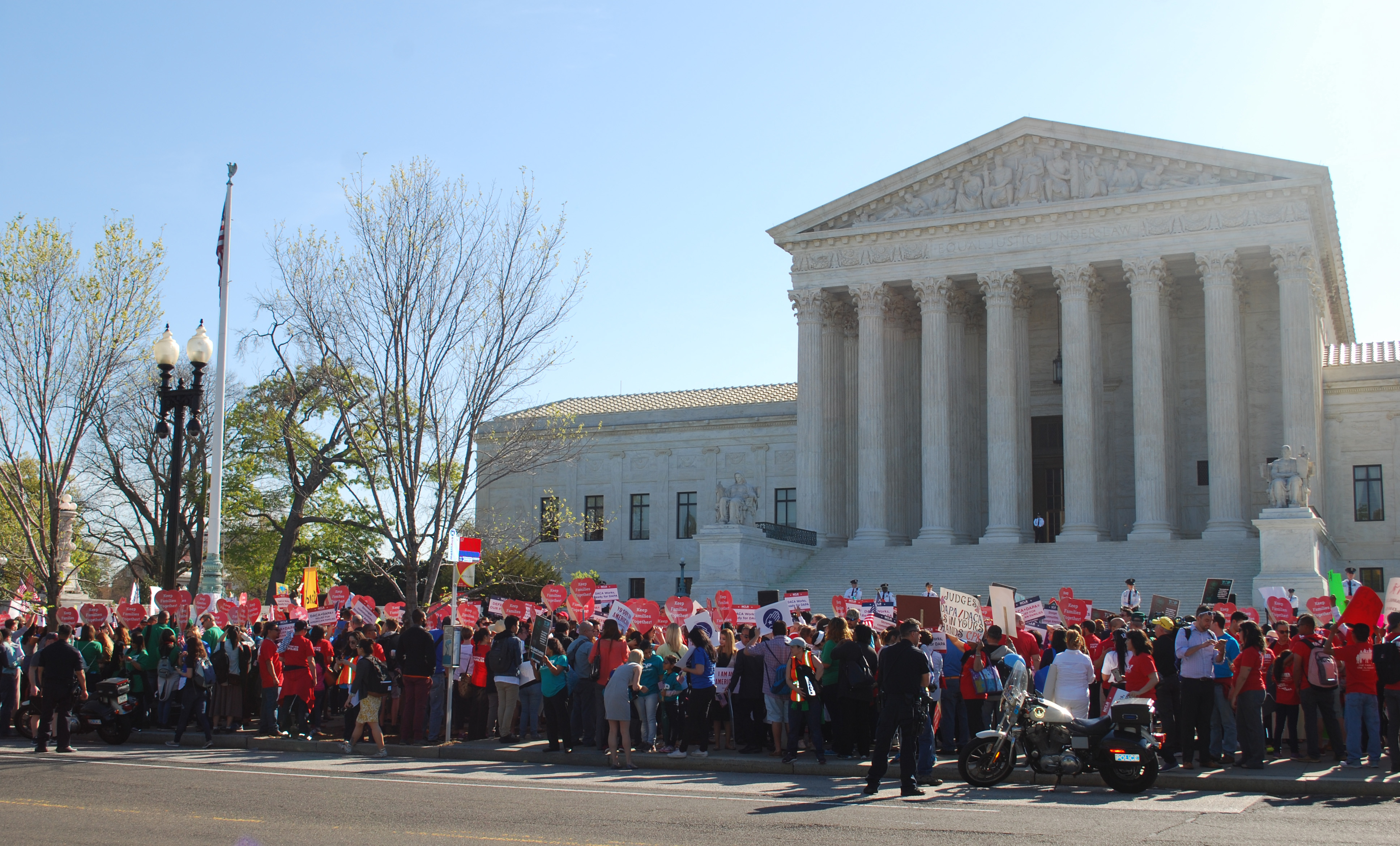 Demonstrators stand outside the U.S. Supreme Court on April 18 as the court hears oral arguments regarding the legality of two Obama Administration policies that would defer deportation for about 5 million immigrants. Photo by Walker Weatherly, Board of Church and Society