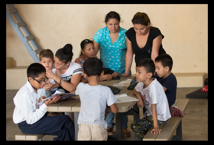 Mothers and children gather around a table in the playroom at the "Door of Hope" Salvation Army shelter in Tijuana. Photo by Mike DuBose, UMNS.