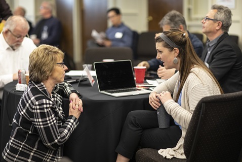 Judi Kenaston, Northeastern Jurisdiction, talks with Michelle Hettman, Southeastern Jurisdiction, during the meeting of the Connectional Table held at United Methodist Discipleship Ministries in Nashville, Tenn., April 2. Photo by Kathleen Barry, UMNS