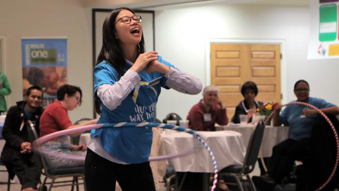 Photo by Anthony Trueheart  Using their hand-made hula-hoops, participants, including this young girl, join in on a friendly competition to see who could hula-hoop the longest.