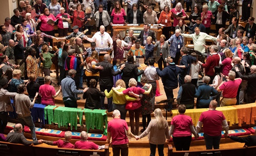 Attendees and guests of the Reconciling Ministries Network convocation pray together at the altar at Belmont United Methodist Church in Nashville, Tenn. LGBTQ United Methodists and their allies expressed hope that a proposal to separate the denomination might pave the way to end what they see as discrimination. Photo by Mike DuBose, UM News.