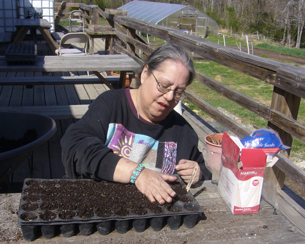 Jocelyn Patterson prepares seedling trays for planting at Anathoth Community Garden in Cedar Grove, N.C. UMNS photos by Ronny Perry.