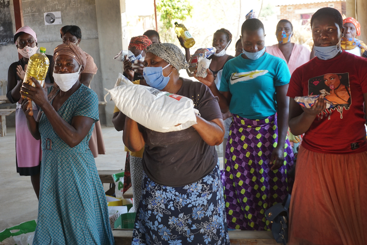 A group of beneficiaries in the Goromonzi Circuit in Harare, Zimbabwe, celebrates after receiving food hampers provided through a United Methodist Committee on Relief Sheltering in Love grant. More than 7 million people in Zimbabwe are facing food insecurity in 2020, according to the World Food Program. Photo by Kudzai Chingwe, UM News. 