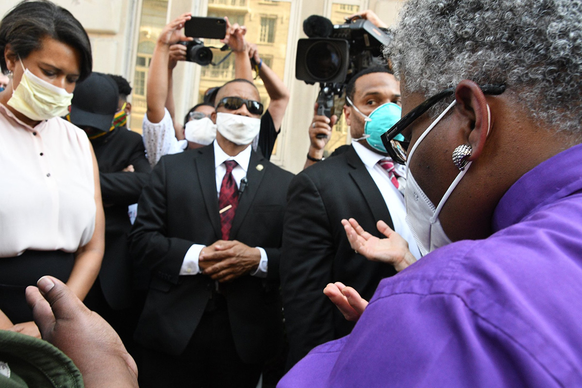 United Methodist Bishop LaTrelle Easterling (right) offers a prayer during an interfaith vigil near the White House on June 3. At left is Washington Mayor Muriel Bowser. United Methodist conferences are confronting the sin of racism through prayers, calls for justice and education on white supremacy. File photo by Melissa Lauber, Baltimore-Washington Conference.