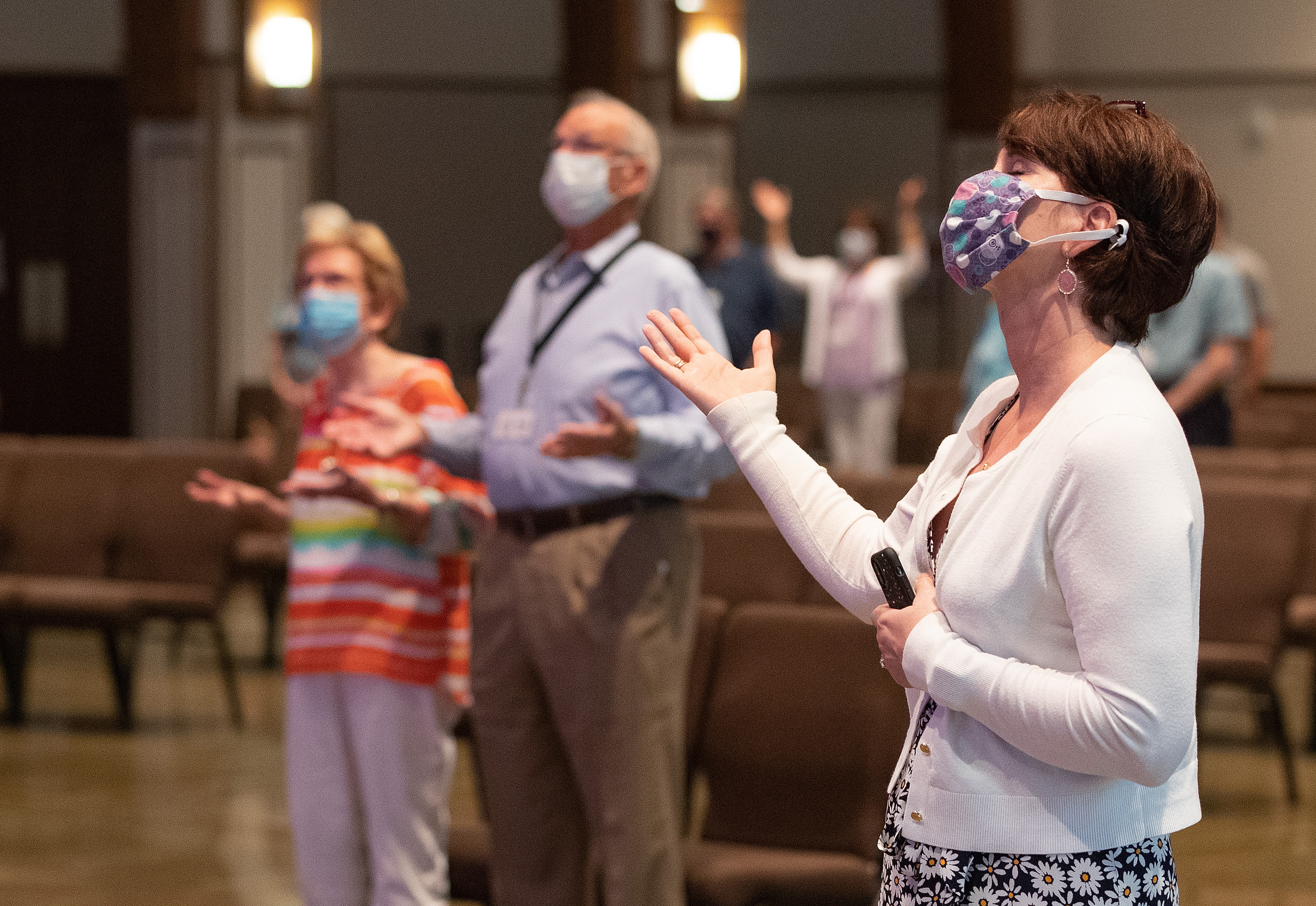 Barbara Layden (front) joins with other parishioners in giving praise during worship at Franklin (Tenn.) First United Methodist Church. The church has adopted safety protocols, including no congregational singing, to help prevent the possible spread of COVID-19. Photo by Mike DuBose, UM News.