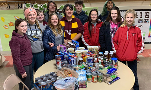 Youth in Madison gather around some of the food items collected. Courtesy Photo.