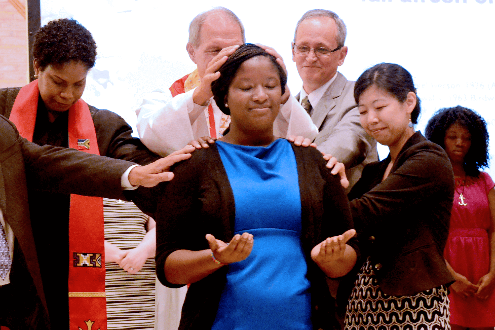 (From left) Regina Henderson, Bishop John Schol, George Howard and Elizabeth Lee commission Kathleen Pryor. Pryor is one of 29 young adult missionaries commissioned and sent into service by the United Methodist General Board of Global Ministries at the Interchurch Center Chapel in New York on Aug. 12, 2013. A GBGM photo by Cassandra Zampini.