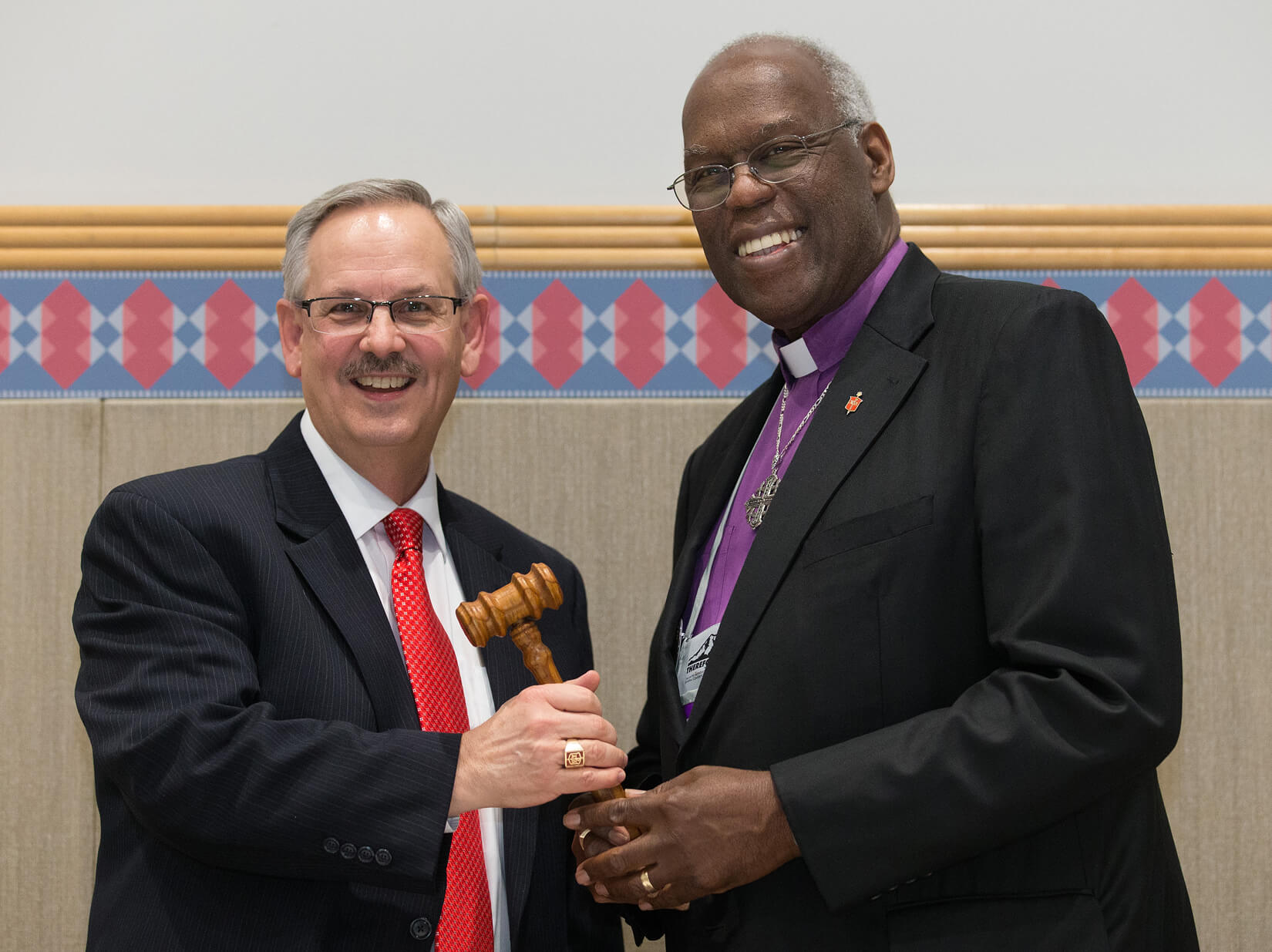 Bishop Bruce R. Ough (left) receives the gavel as incoming president of the United Methodist Council of Bishops from outgoing president Warner H. Brown, Jr. during the 2016 General Conference in Portland, Ore. Photo by Mike DuBose, UMNS