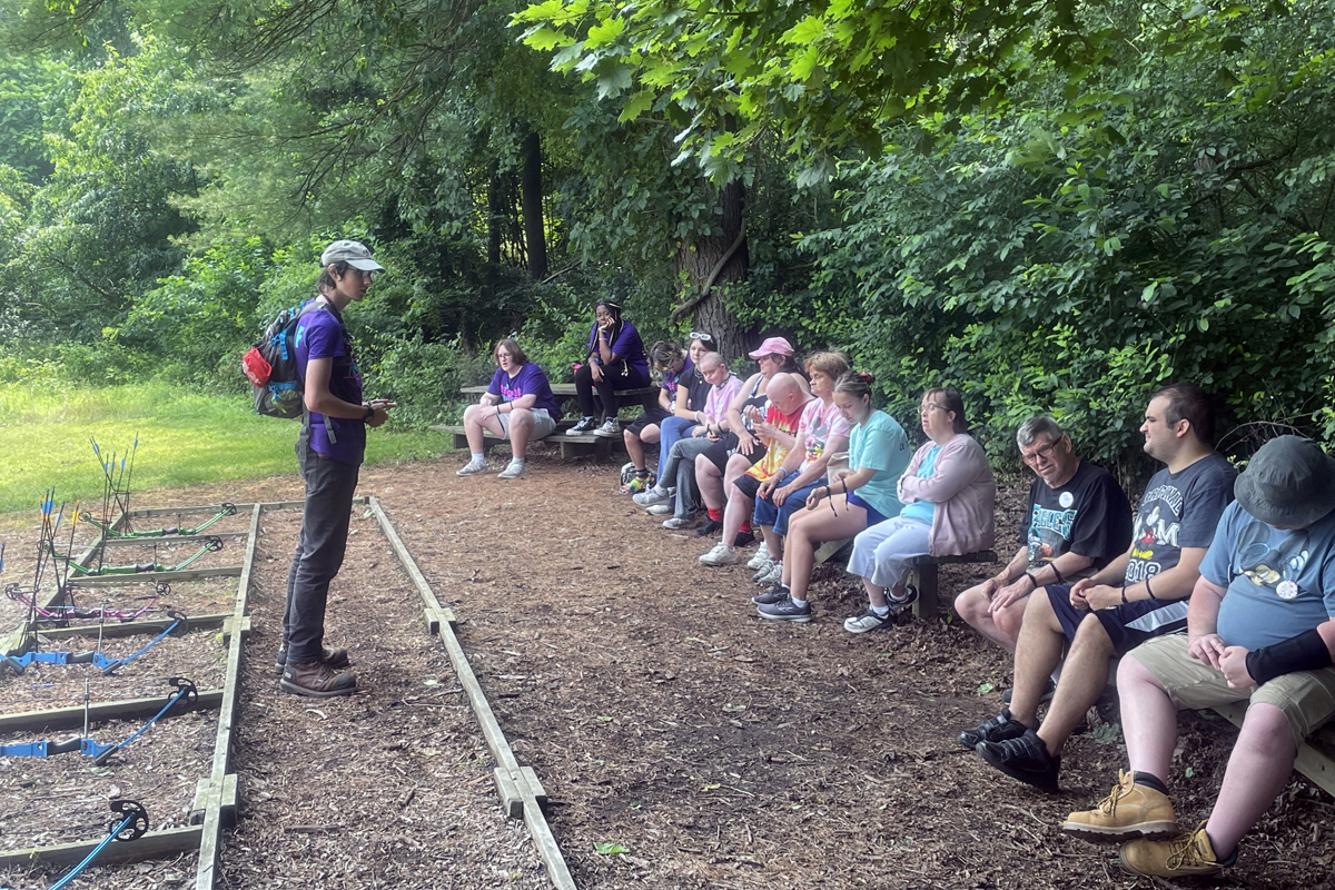 Jordan Wagaman (left) instructs challenge campers June 29, before they try their hand at archery at Innabah Camp and Retreat Center in Spring City, Pa. The campers are taking part in a week-long camp for adults with developmental disabilities. Photo by Jim Patterson, UM News.