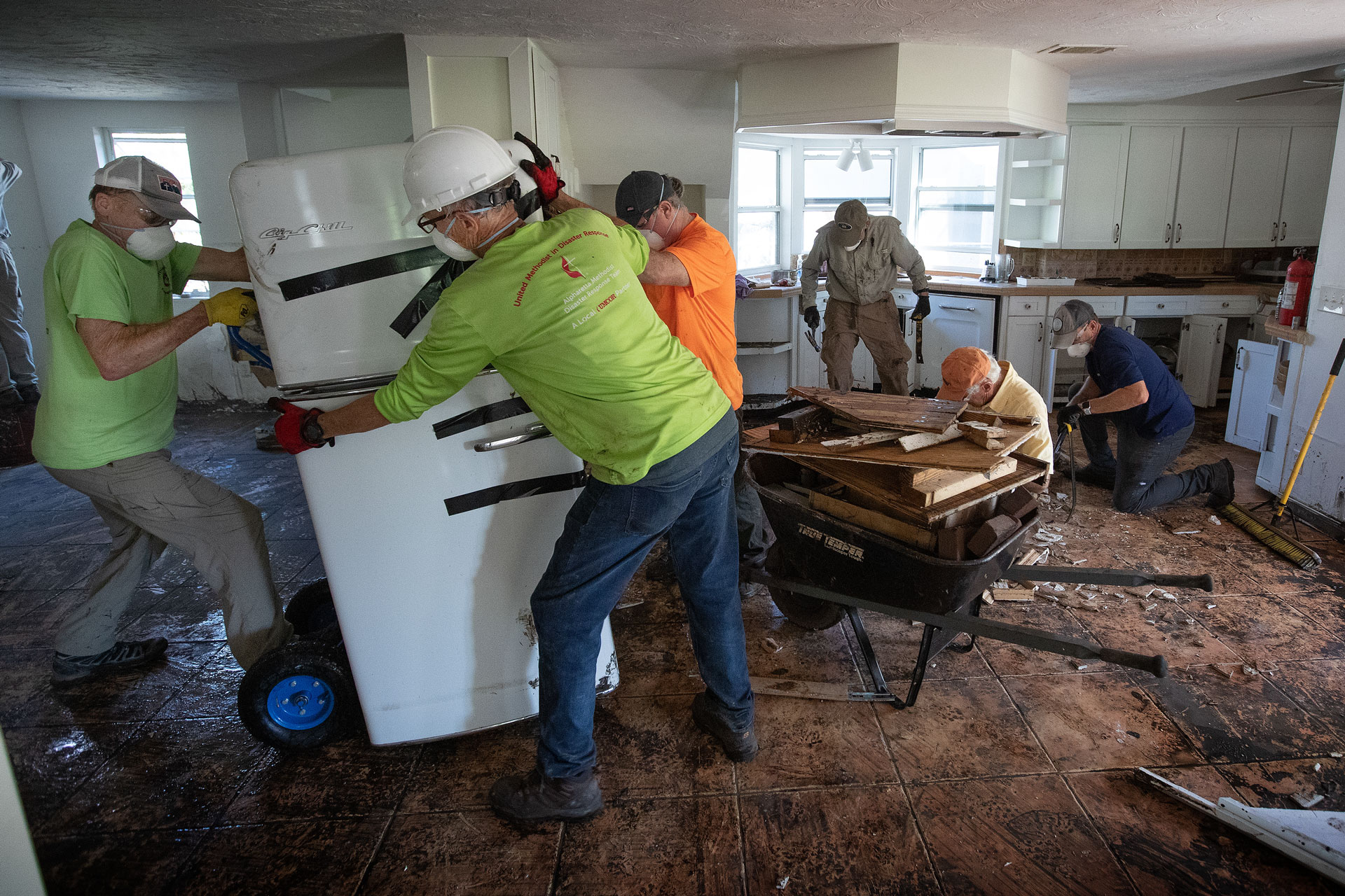 Members of a volunteer team from the North Georgia Conference of The United Methodist Church clean out a home in Fort Myers, Fla., that was flooded by Hurricane Ian. Photo by Mike DuBose, UM News.