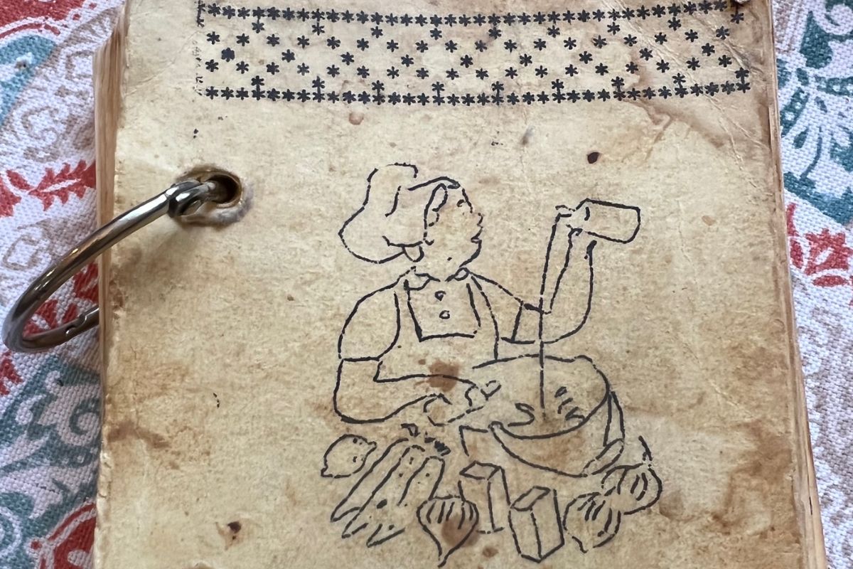 The spiral clips and artwork by hand on this vintage cookbook represents a labor intensive effort by the church in presenting their recipes. (Photo courtesy of Lilla Marigza, United Methodist Communications.)