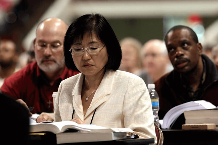 Delegates study a petition printed in the Daily Christian Advocate during the 2008 United Methodist General Conference in Fort Worth, Texas. A UMNS file photo by Maile Bradfield.