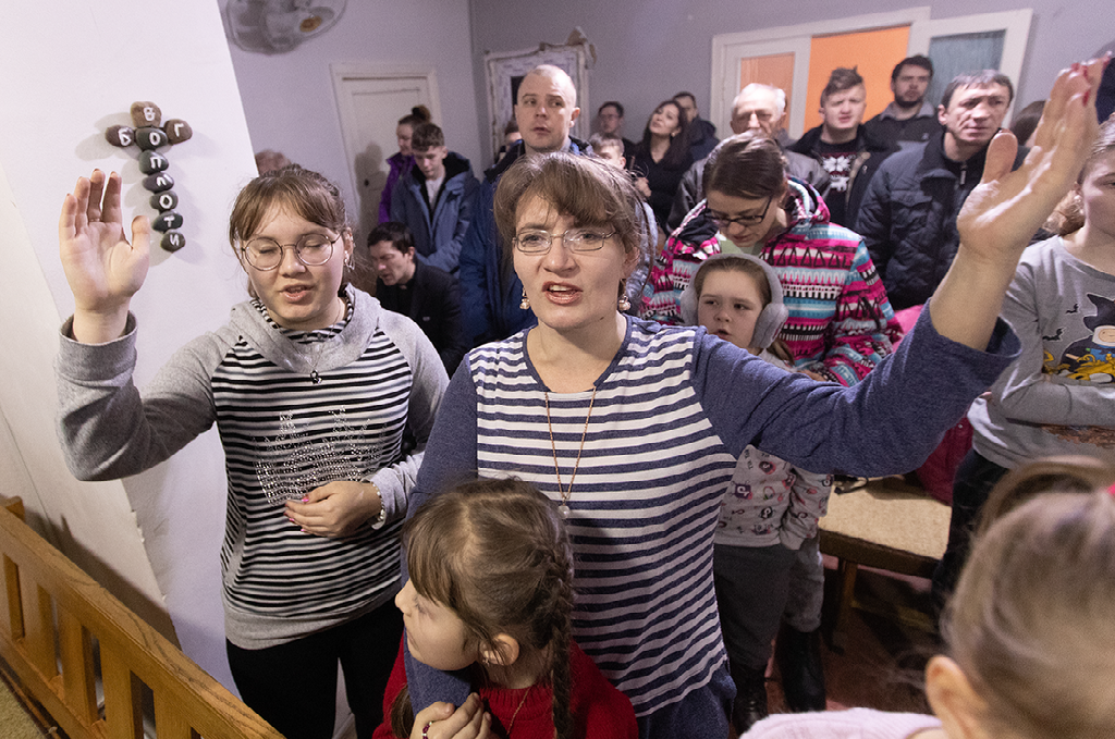 Eugenia Tachieva (left) and Irina Tachieva raise their hands in praise during worship at Livespring United Methodist Church in Kara-Balta, Kyrgyzstan. Photo by Mike DuBose, UM News.