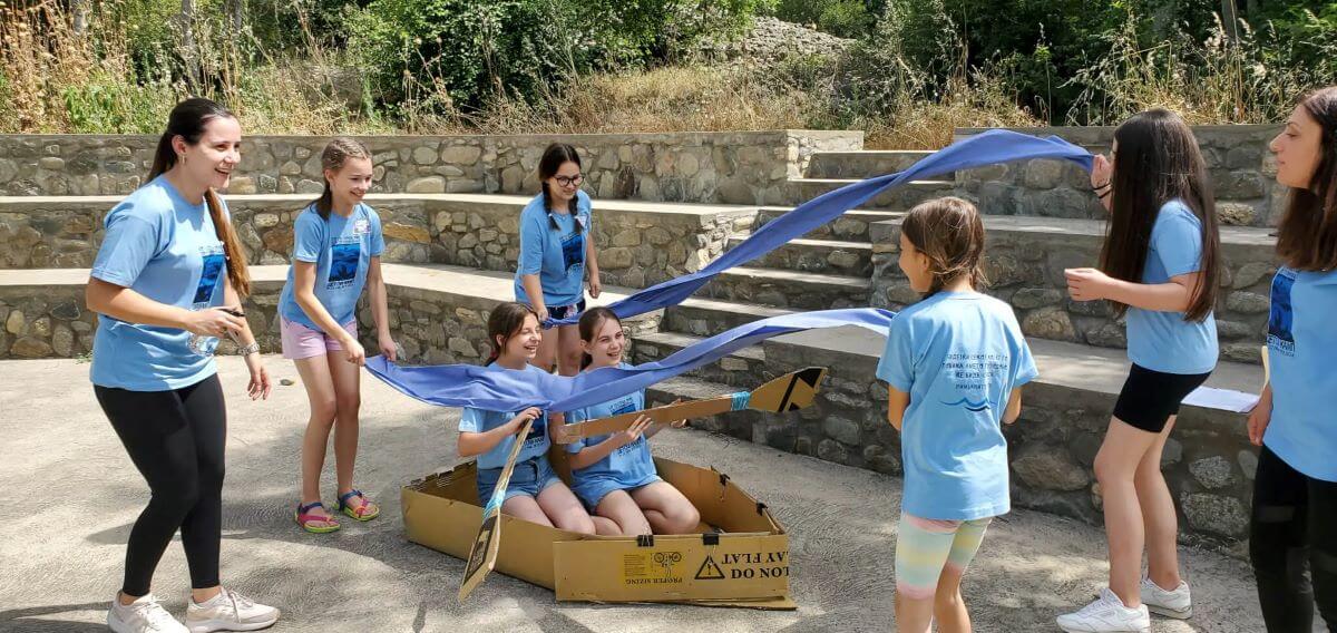 Children participating in the North Macedonia UMC summer church camp act out the storm during Jonah’s voyage to Tarshish. (Photo: Courtesy of Jennifer Moore)