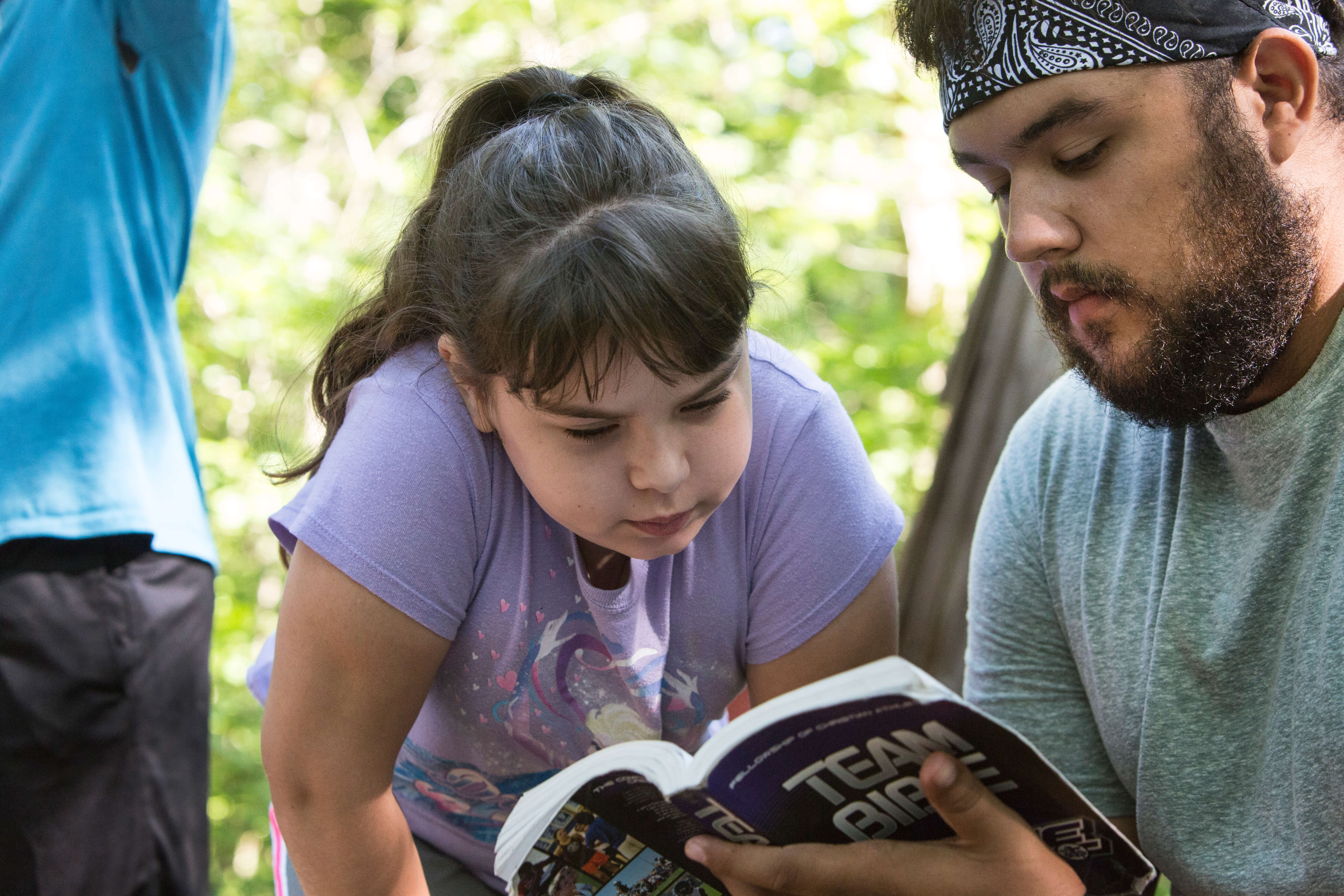Camper Klaira Hargrove studies the Bible with counselor Emilio Almendarez during morning worship at Cedar Crest Camp in Lyles, Tennessee. Cedar Crest has been owned and operated by the Tennessee Annual Conference of the United Methodist Church since 1959. Photo by Kathleen Barry, United Methodist Communications .