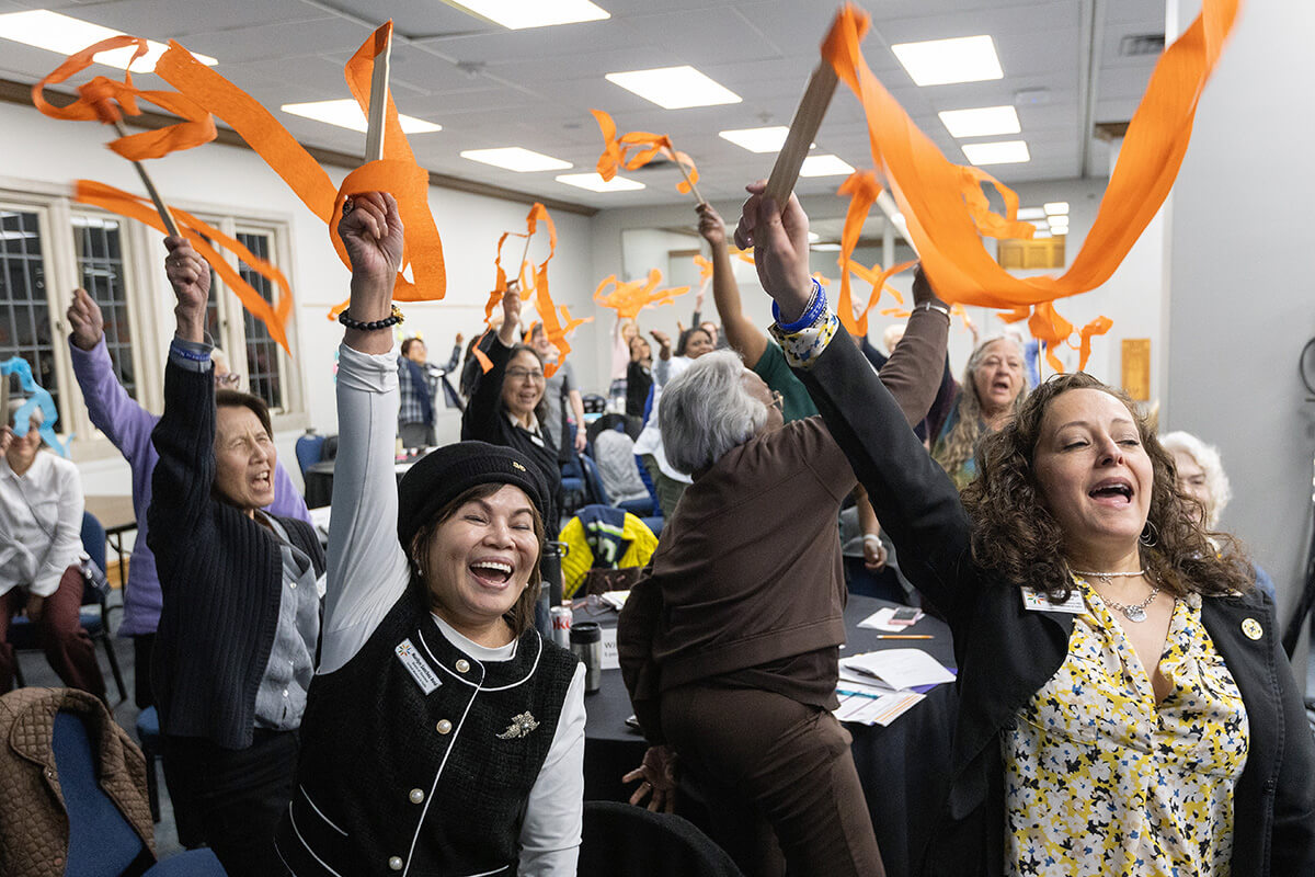 Members of the United Women in Faith Program Advisory Group celebrate the announcement of Assembly 2026, scheduled for May 15-17, 2026, in Indianapolis. Board and program advisory group members met in person March 6-9 at Scarritt Bennett Center in Nashville, Tenn., the organization’s first in-person meeting since early 2020. Pictured in the foreground are board member Marilyn Sanchez Reid of the Western Jurisdiction and Vice President Heidi Careaga of the North Central Jurisdiction. Photo by Mike DuBose, UM News. 
